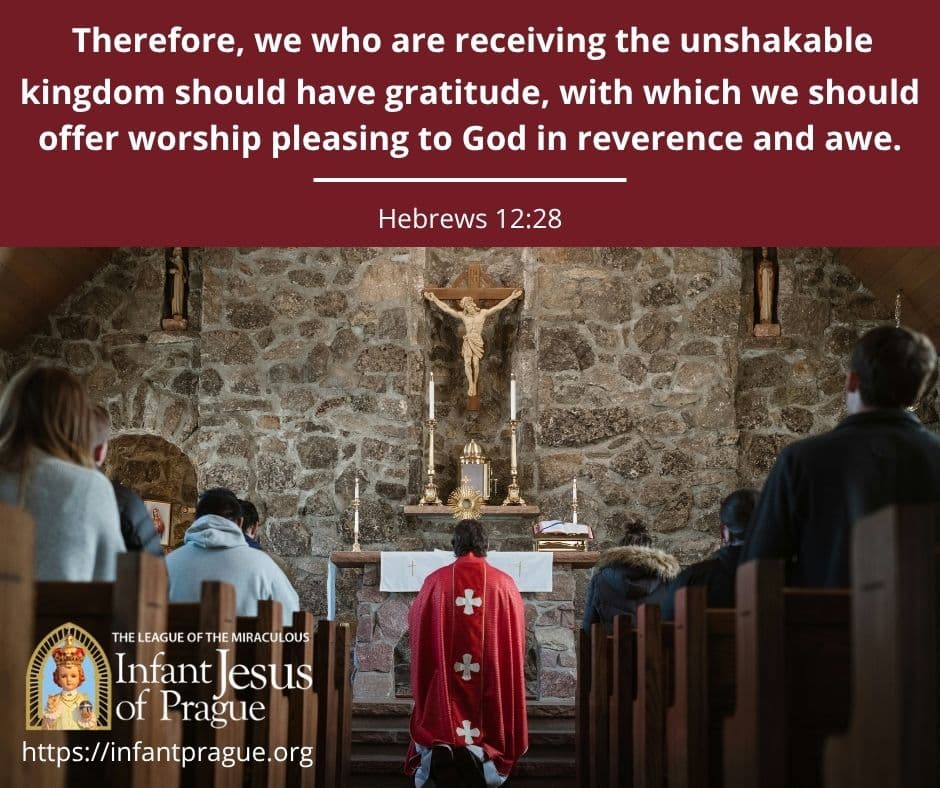 Aisle view of priest kneeling in front of monstrance during adoration with parishioners seated in pews
