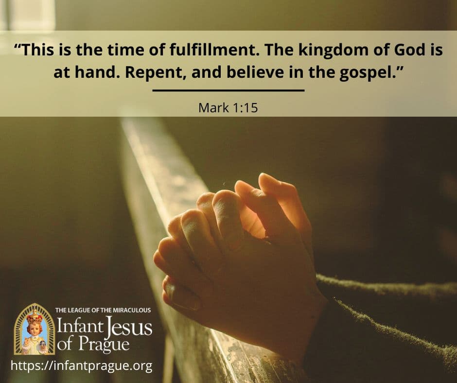 prayer hands with interlocked fingers resting on a wooden pew