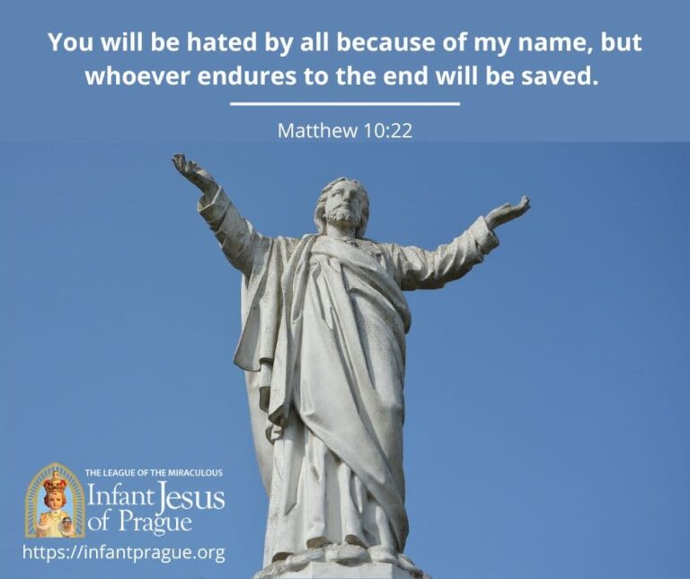 white concrete statue of Jesus with arms extended at his sides and clear blue sky background