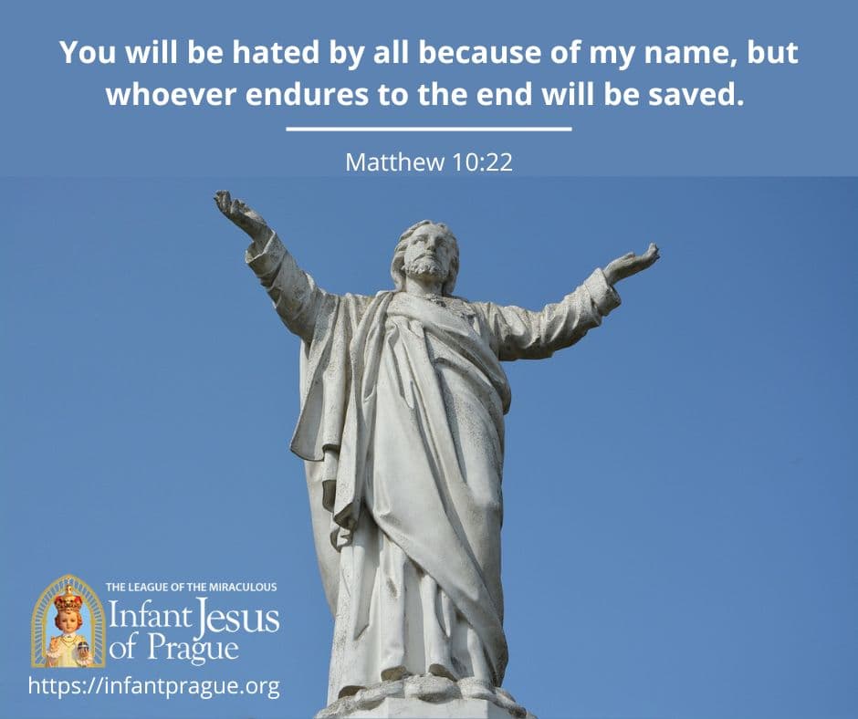 white concrete statue of Jesus with arms extended at his sides and clear blue sky background