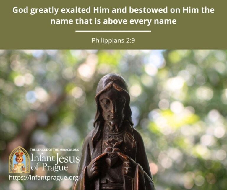 Statue of Jesus with bowed head pointing to Sacred Heart on His chest