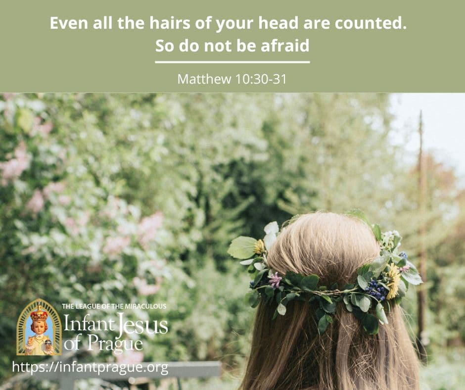 londe long haired person with a leafy flower crown and green plants in the distance